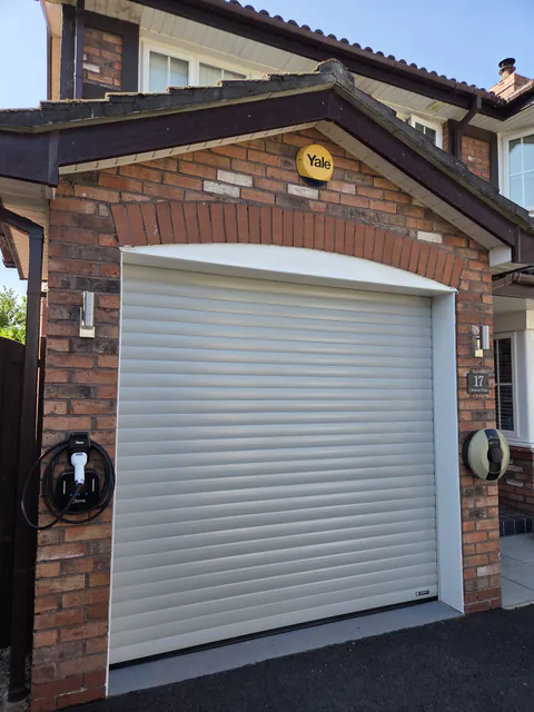 Agate Grey roller garage door fitted to a brick garage
